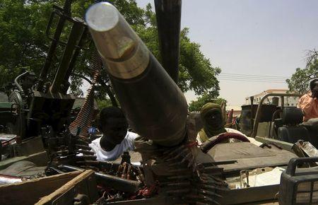 Men sit inside vehicles of the Justice and Equality Movement (JEM) rebels, after Sudanese Armed Forces (SAF) and the Rapid Support Forces (RSF) victory celebrations during a display in Niyla