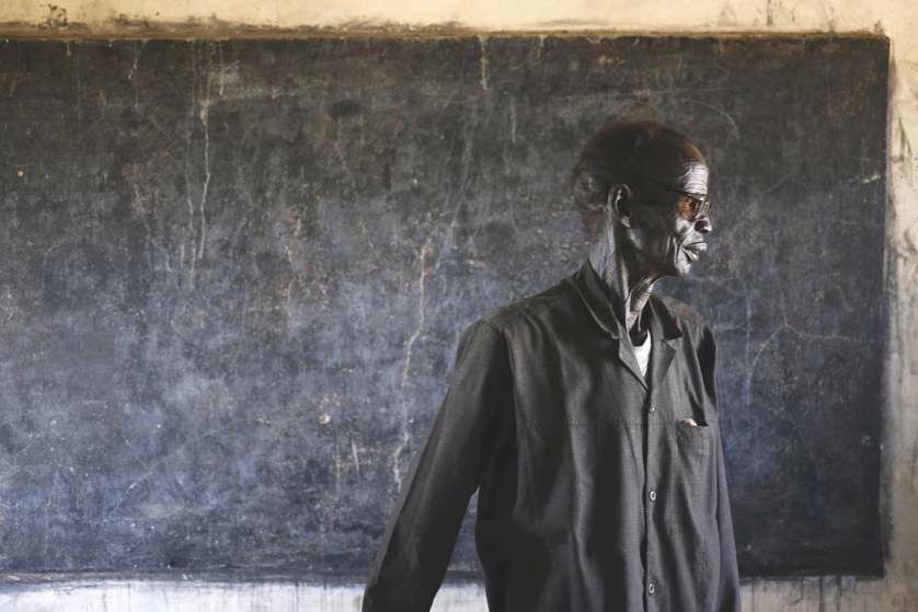 An elderly man walks out of a polling station located in a school during a referendum in the town of Abyei