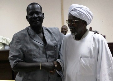 Sudanese Al-Amer Mokhtar Papo (R) a leader of the Misserya Arab tribe and his counterpart from the Dinka Ngok tribe, Kual Deng Majok shake hands after signing a peace agreement in the town of Kadugli north of Abeyi on January 13, 2011. The feuding ethnic groups of Sudan's flashpoint district of Abyei on the north-south border broke the ice in peace talks on Thursday after deadly clashes at the weekend. AFP PHOTO / KHALED DESOUKI        (Photo credit should read KHALED DESOUKI/AFP/Getty Images)